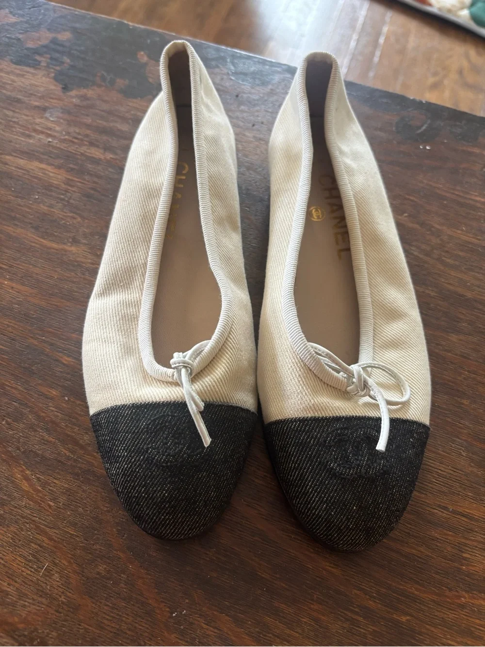 CHANEL Ivory Canvas Ballet Flats with Black Cap Toe and Bow